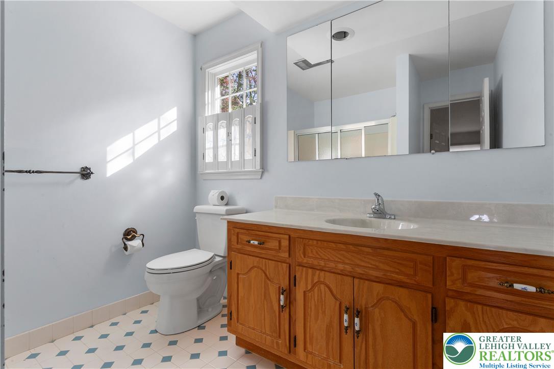 434 Schoeneck Avenue Nazareth, PA 18064 - Photo 24 of 39 a bathroom with a granite countertop sink a toilet a mirror and vanity