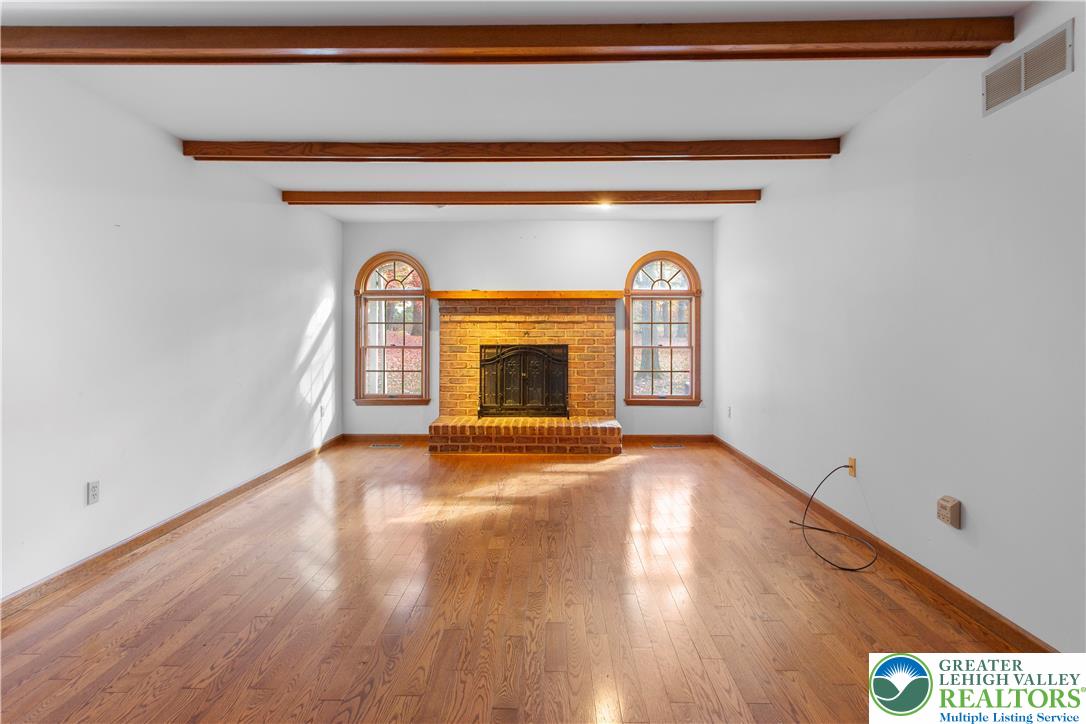 434 Schoeneck Avenue Nazareth, PA 18064 - Photo 9 of 39 a view of an empty room with wooden floor a fireplace and a window
