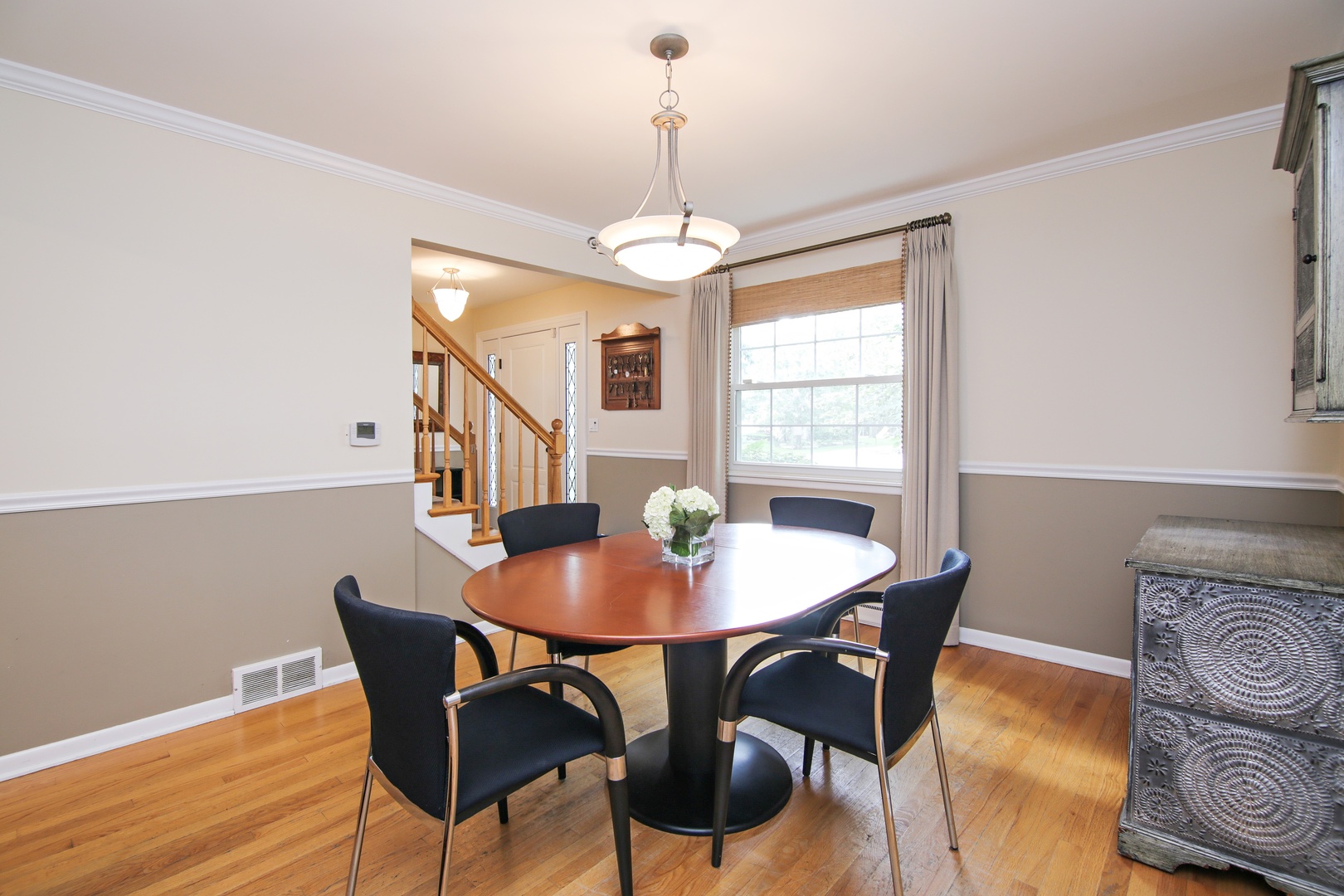 1422 Hackberry Road Deerfield, IL 60015 - Photo 6 of 12 a dining room with furniture a chandelier and wooden floor