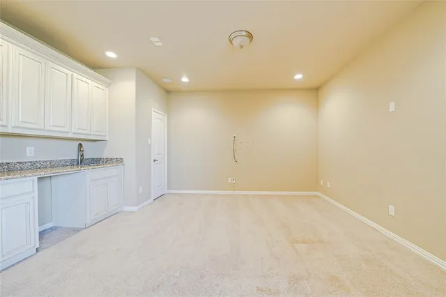 a view of kitchen with granite countertop cabinets and sink