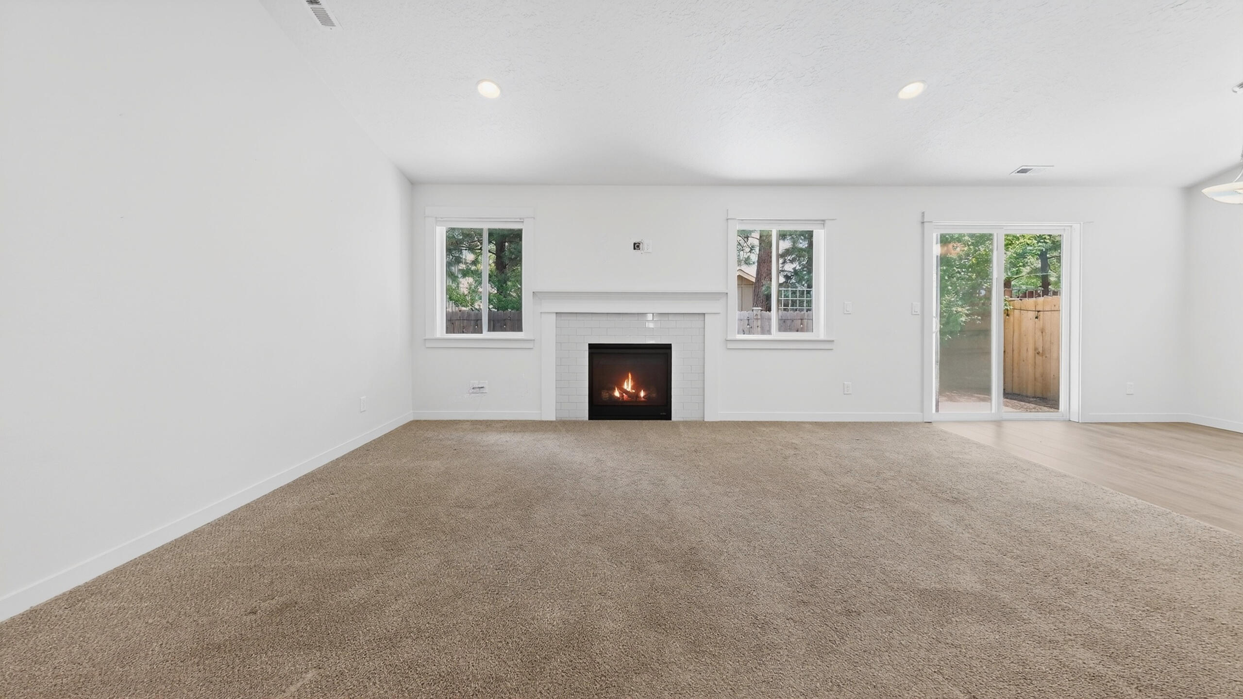 680 McKinney Ranch Road Sisters, OR 97759 - Photo 14 of 41 an empty room with windows and fireplace