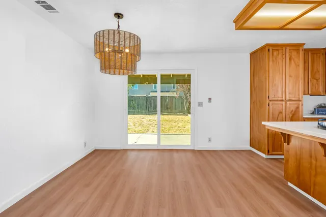 a kitchen with stainless steel appliances a sink a stove cabinets counter space and a window