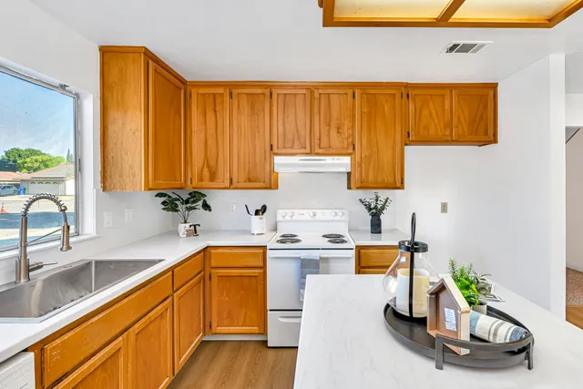 a kitchen with a sink and a refrigerator