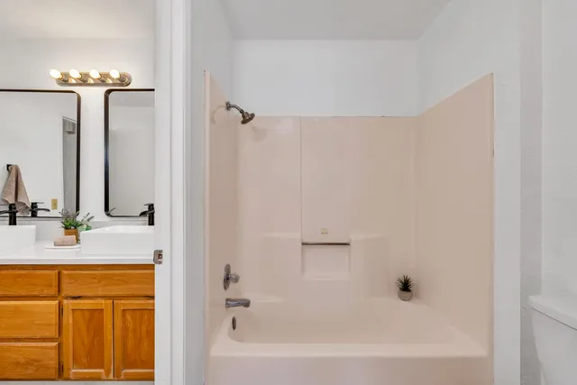 a bathroom with a double vanity sink and a mirror