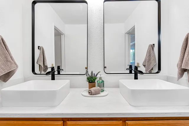 a view of a hallway with wooden floor and entryway
