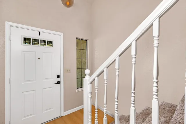 a view of entryway and hall with wooden floor