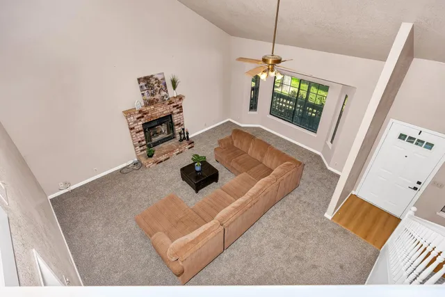 an empty room with a window and a ceiling fan