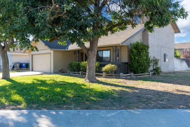 a front view of house with yard and green space