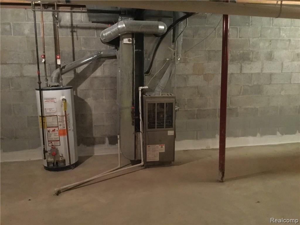 4711 Martin Road Capac, MI 48014 - Photo 20 of 29 Basement hot water tank and furnace