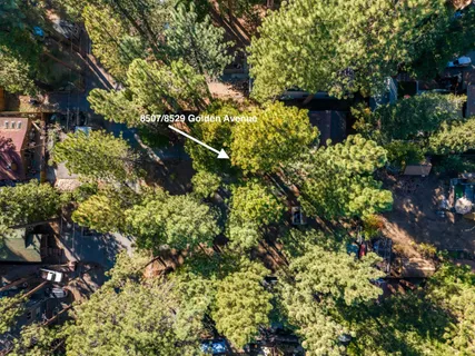a backyard of a house with lots of green space and a fountain