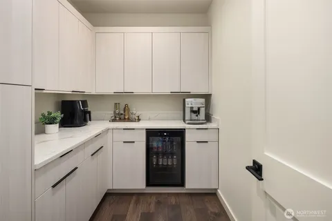 a kitchen with stainless steel appliances granite countertop white cabinets and white appliances