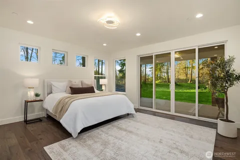 a bedroom with a balcony a bed and a television