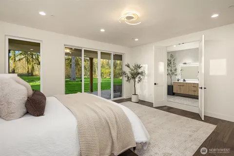 a spacious bedroom with a large bed and a large window