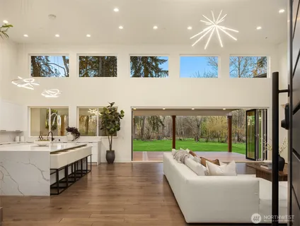 a living room with kitchen island furniture and a large window