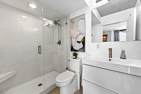 a bathroom with a sink toilet and shower