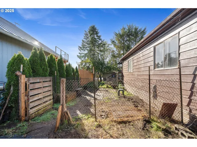 a backyard of a house with wooden floor and outdoor seating