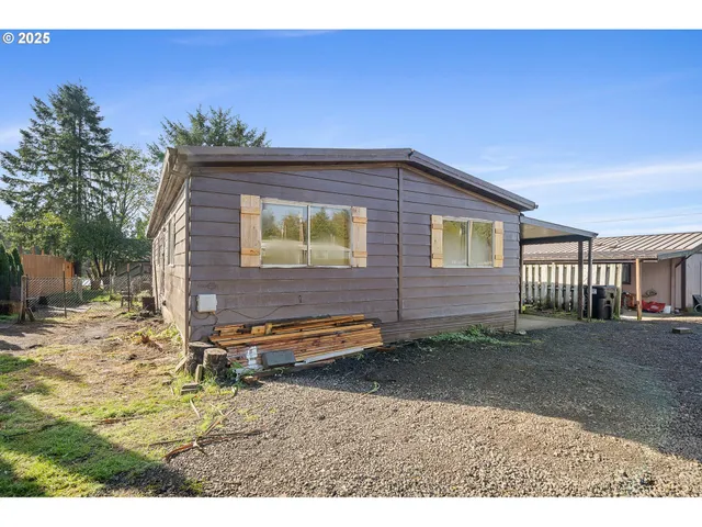 a backyard of a house with barbeque oven table and chairs