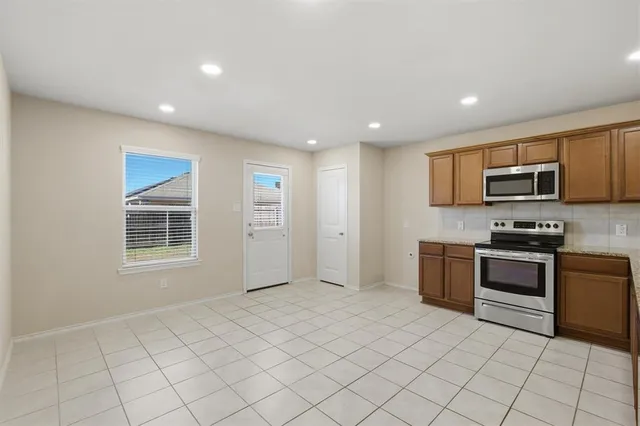 a large kitchen with a sink and cabinets