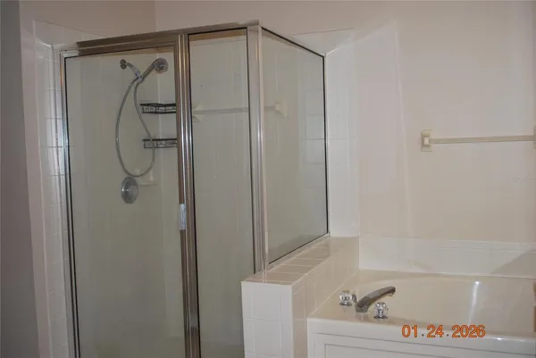 a bathroom with a shower and a bath tub
