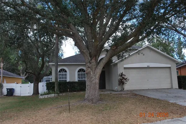 a view of a house with a yard and garage