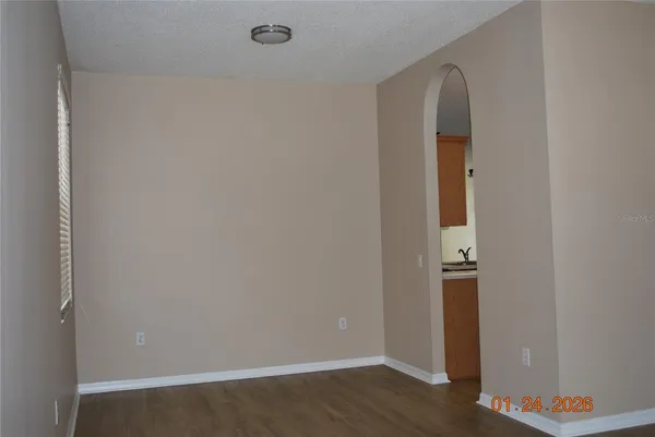 an empty room with wooden floor and closet