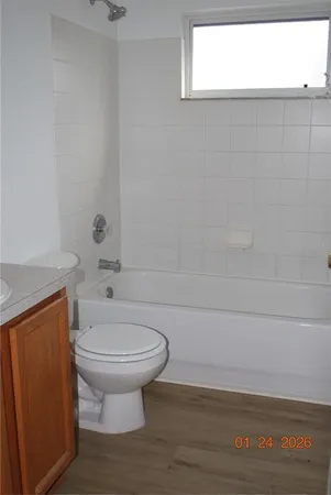 a bathroom with a sink a toilet and bathtub