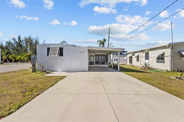 a front view of a house with a yard and a garage