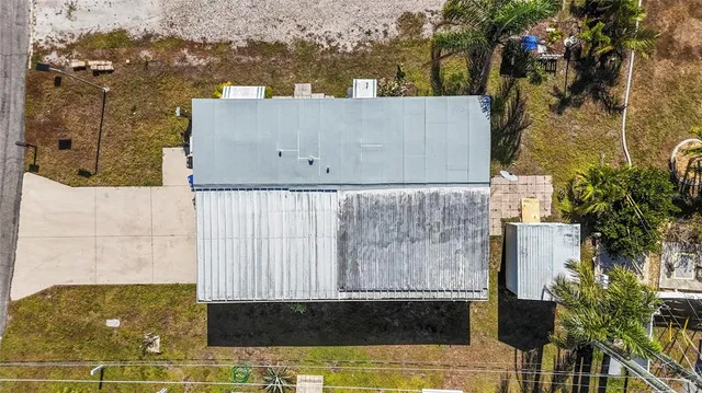 an aerial view of a house with parking space