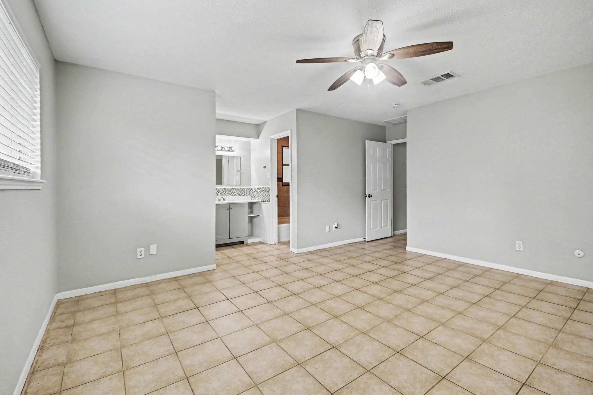 4306 Oneida Street Pasadena, TX 77504 - Photo 13 of 23 a view of a room with a chandelier fan and windows