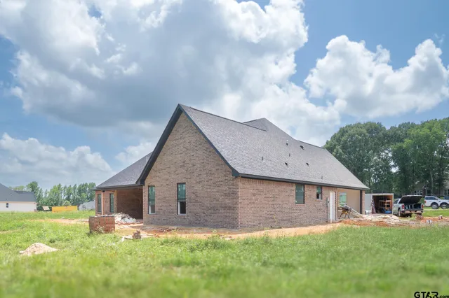 a front view of house with yard and trees