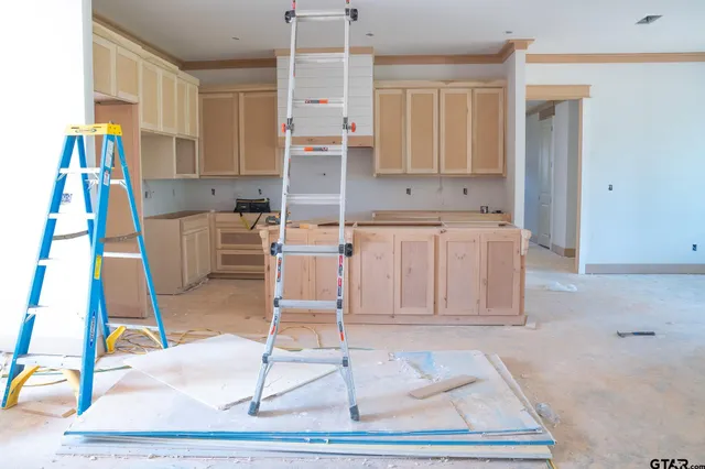 a living room with a gaming space counter space and appliances
