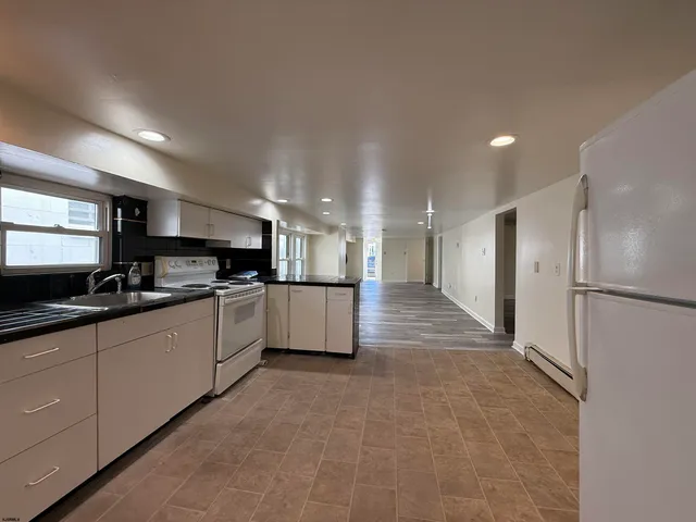 a large kitchen with cabinets and stainless steel appliances