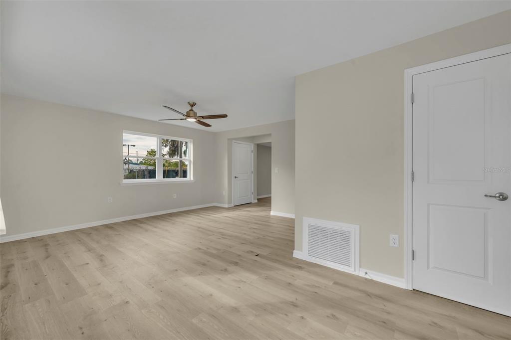 31201 Merry Road Tavares, FL 32778 - Photo 4 of 40 an empty room with windows and ceiling fan