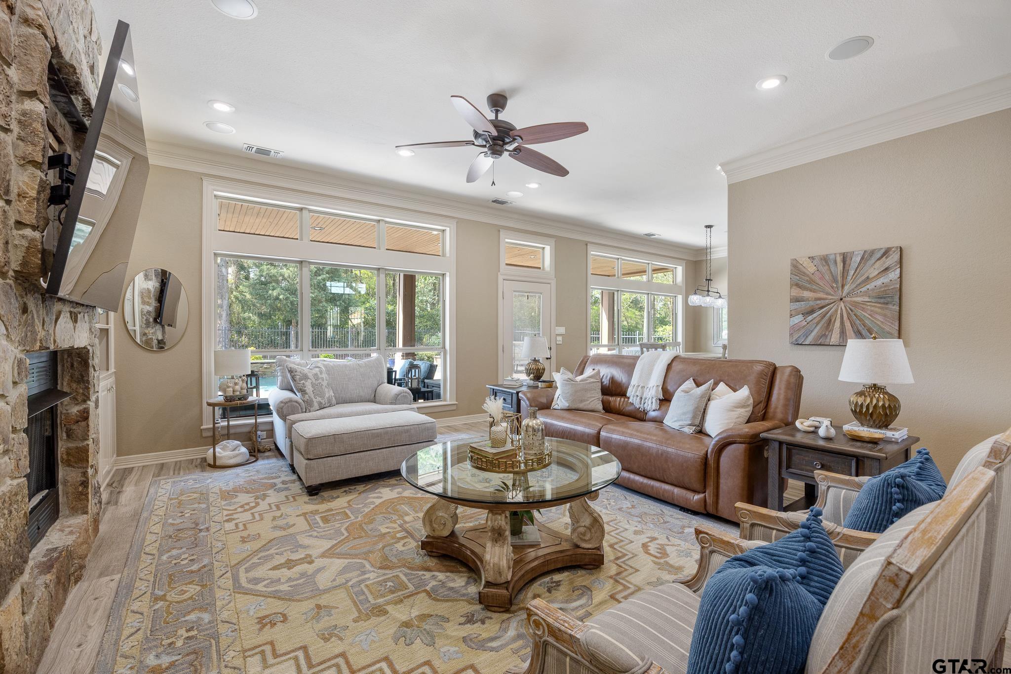 5875 Stonegate Trail Tyler, TX 75703 - Photo 11 of 47 a living room with furniture a fireplace and a large window