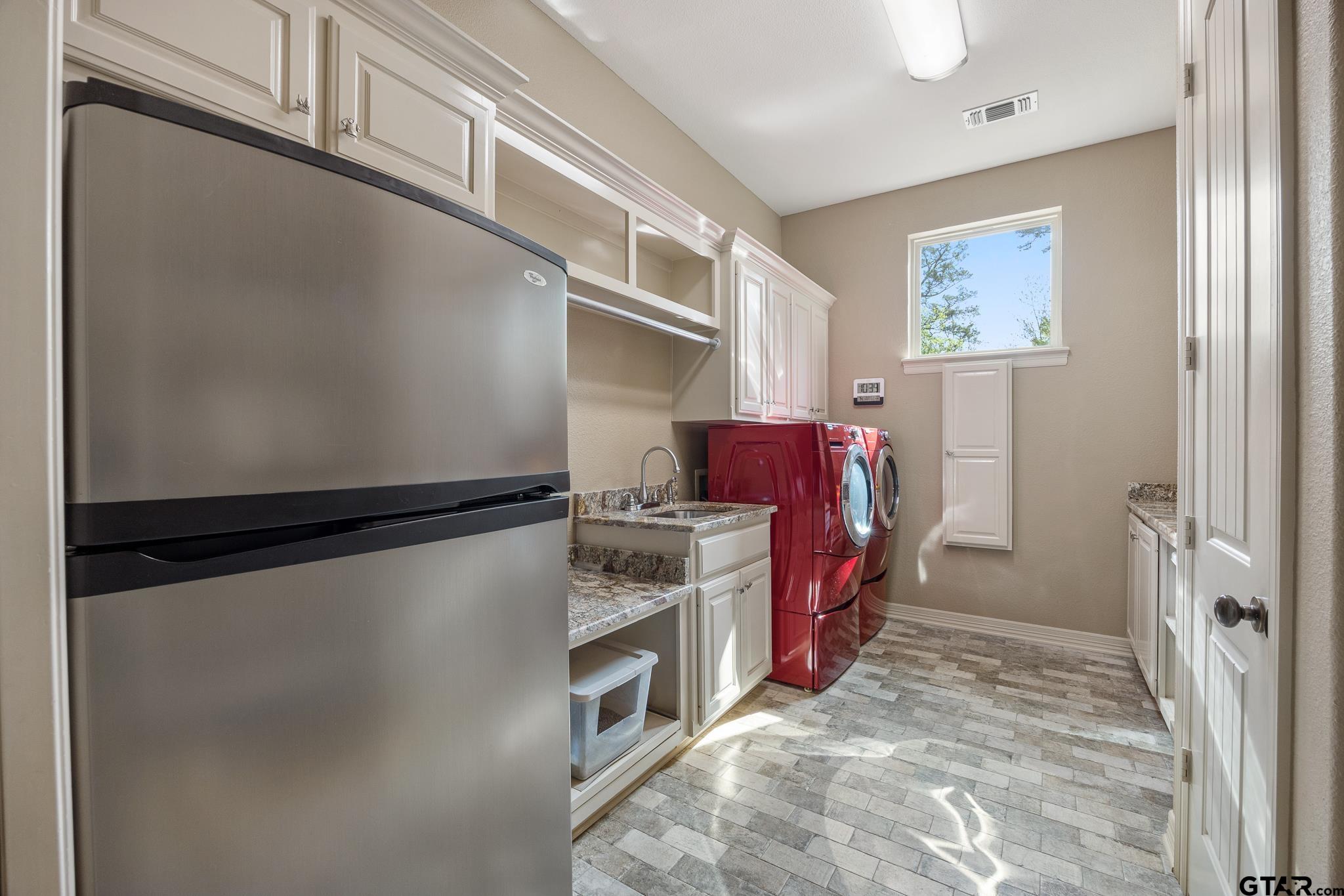 5875 Stonegate Trail Tyler, TX 75703 - Photo 13 of 47 a kitchen with stainless steel appliances granite countertop a refrigerator and a stove