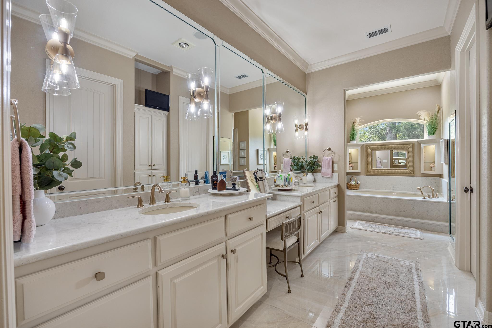 5875 Stonegate Trail Tyler, TX 75703 - Photo 17 of 47 a spacious bathroom with a granite countertop sink mirror and bathtub