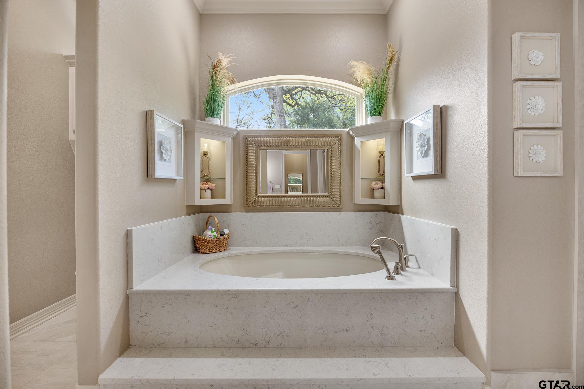 5875 Stonegate Trail Tyler, TX 75703 - Photo 19 of 47 a bathroom with a tub sink and mirror