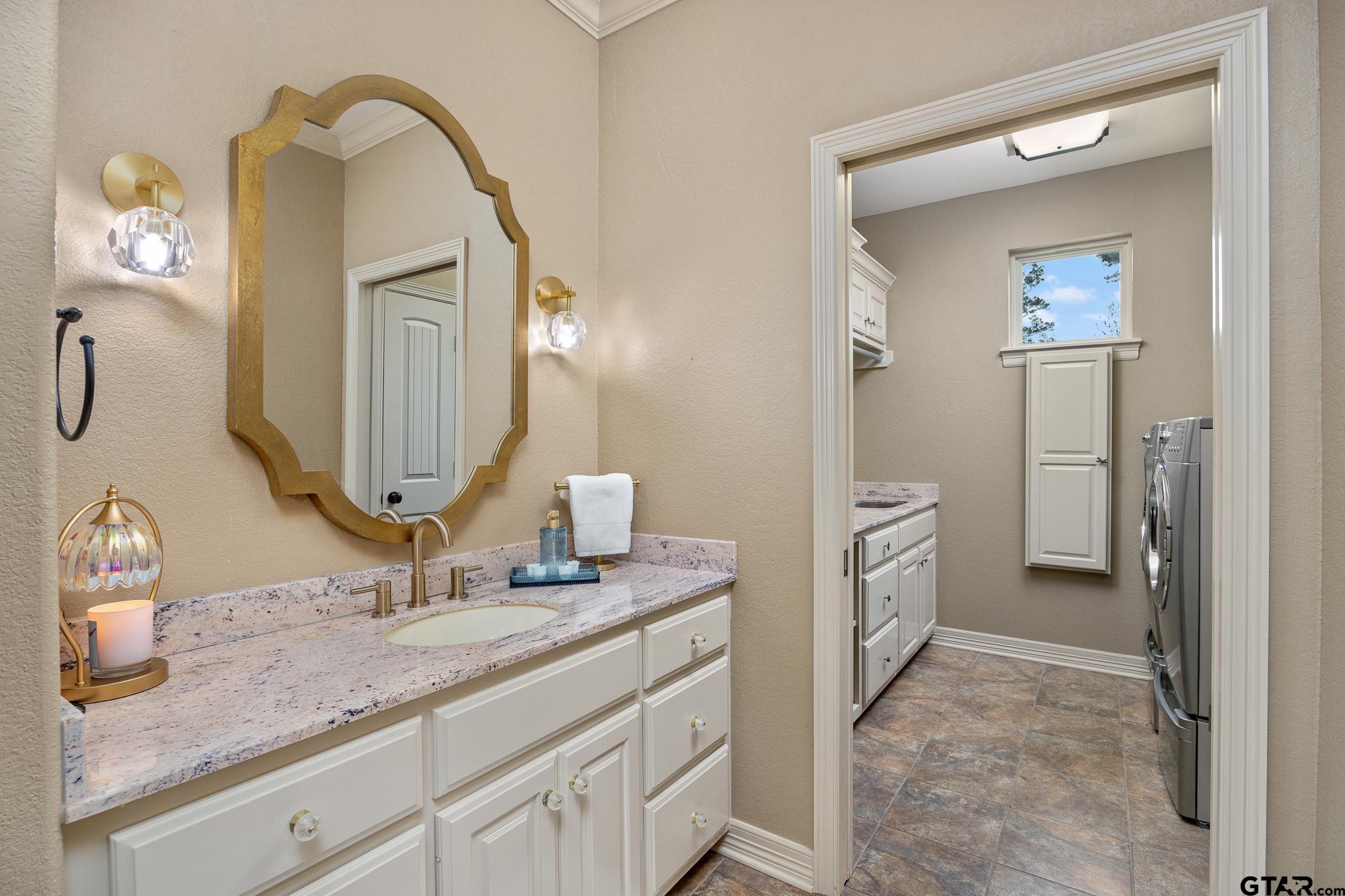 5875 Stonegate Trail Tyler, TX 75703 - Photo 26 of 47 a bathroom with a granite countertop sink vanity and mirror