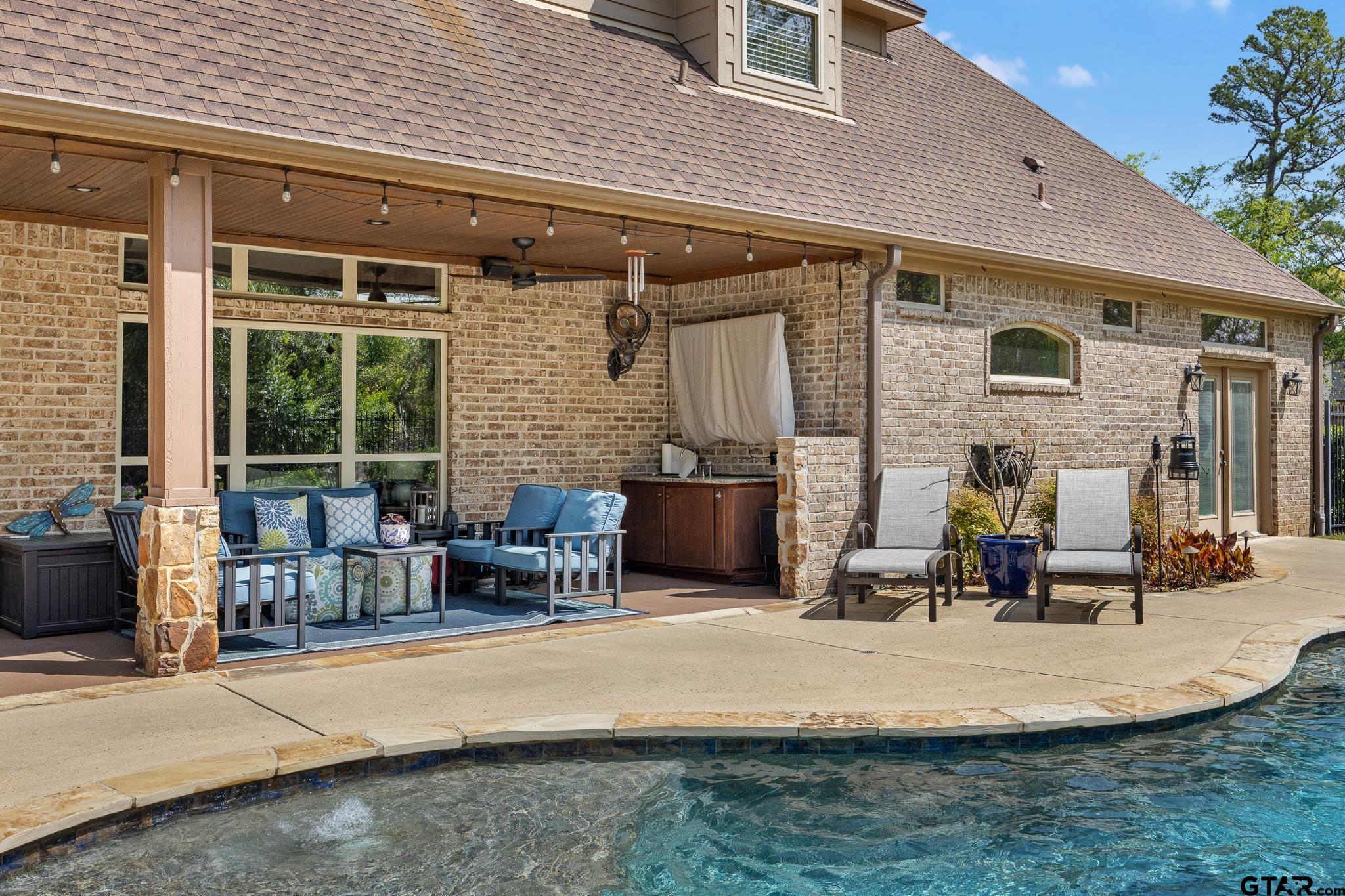 5875 Stonegate Trail Tyler, TX 75703 - Photo 33 of 47 a backyard of a house with outdoor seating
