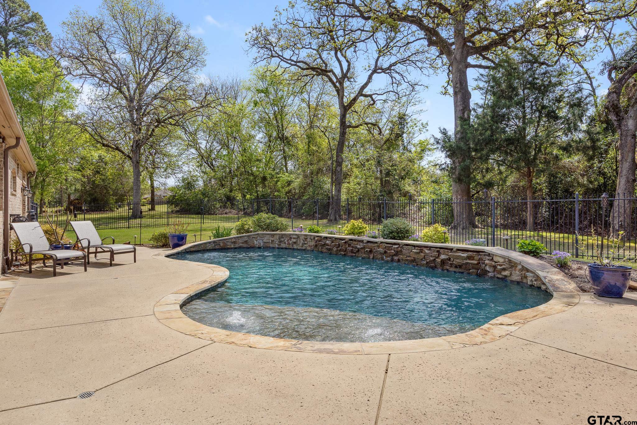 5875 Stonegate Trail Tyler, TX 75703 - Photo 35 of 47 a view of a swimming pool with a sitting area