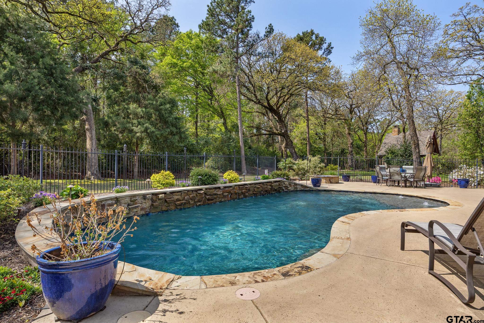 5875 Stonegate Trail Tyler, TX 75703 - Photo 36 of 47 a view of a swimming pool with a patio