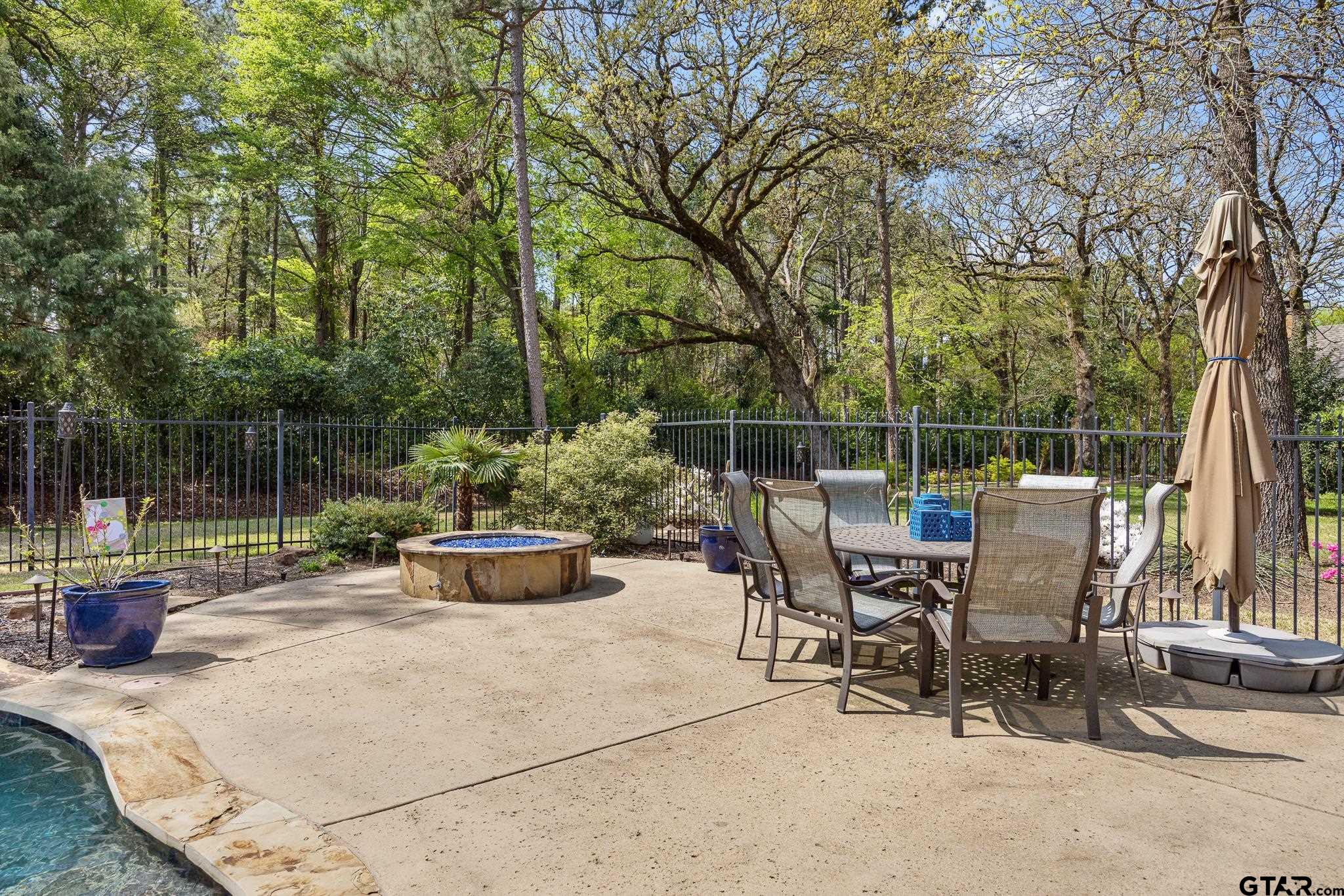 5875 Stonegate Trail Tyler, TX 75703 - Photo 37 of 47 a view of a patio with couches chairs and a small yard