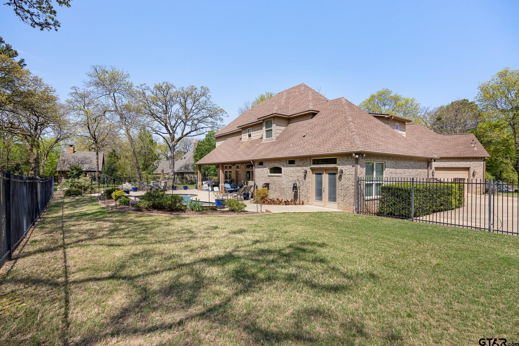 5875 Stonegate Trail Tyler, TX 75703 - Photo 38 of 47 a view of a house with a yard and sitting area