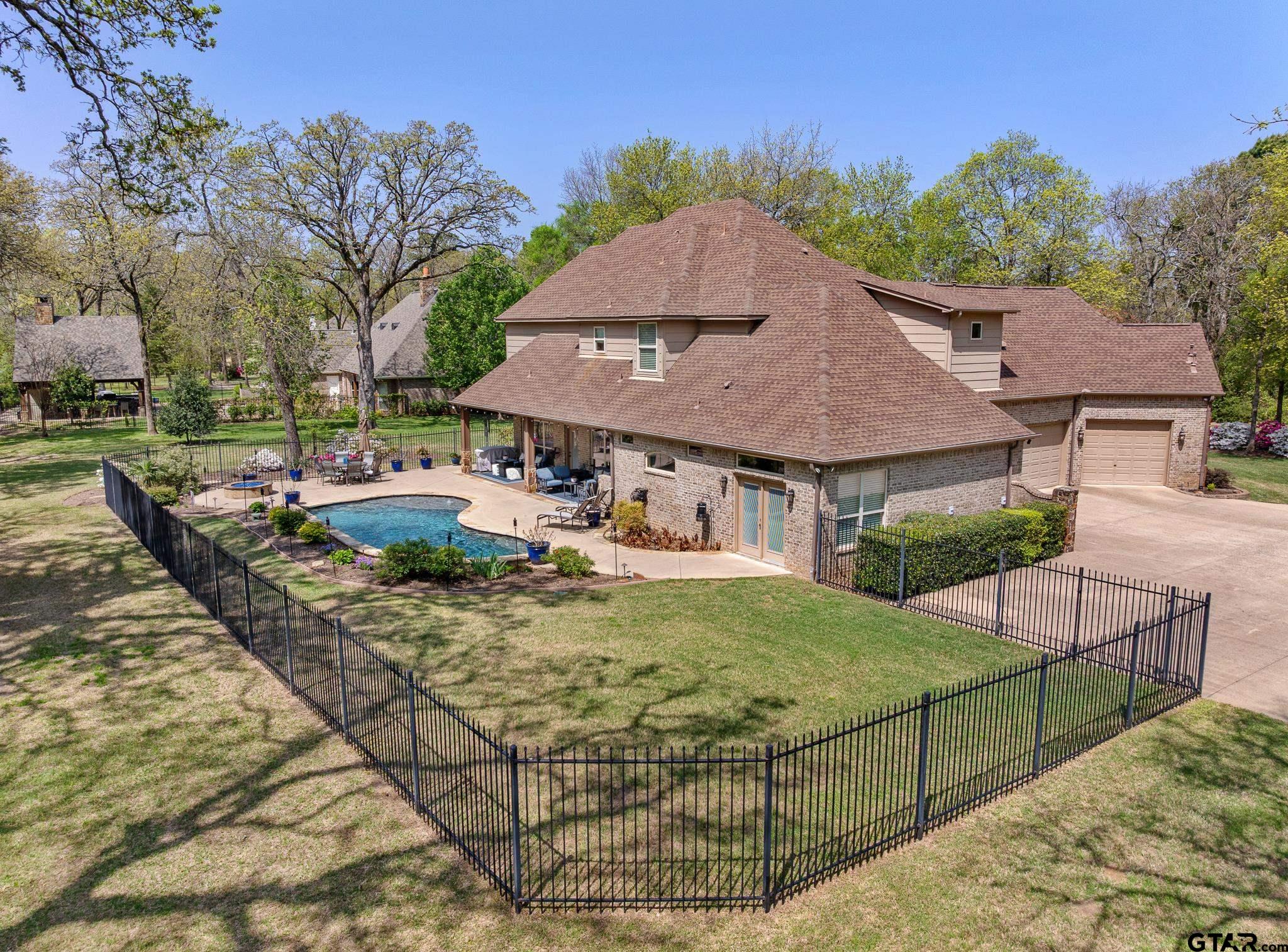 5875 Stonegate Trail Tyler, TX 75703 - Photo 39 of 47 a view of a house with backyard porch and sitting area