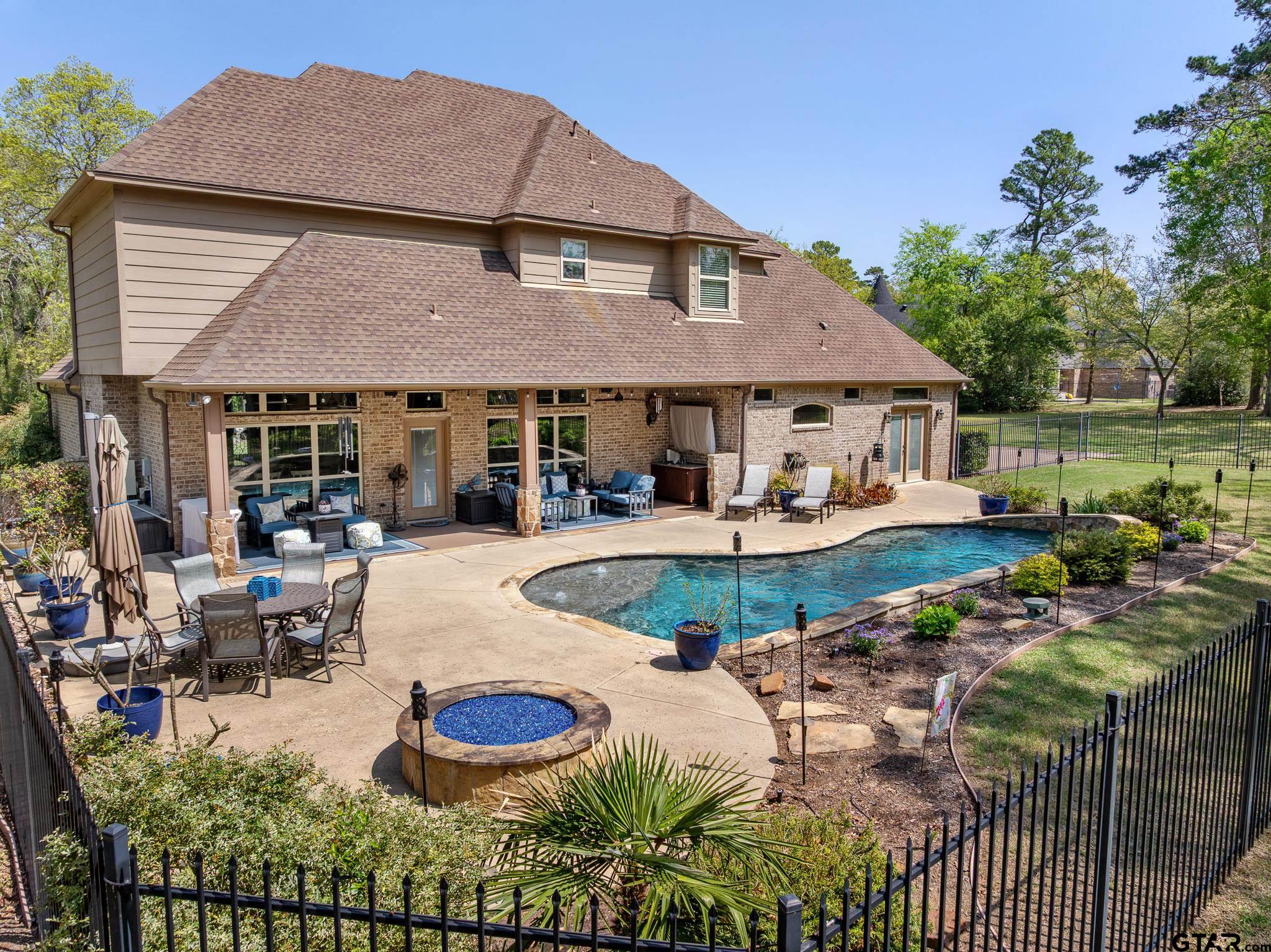 5875 Stonegate Trail Tyler, TX 75703 - Photo 40 of 47 a view of a house with swimming pool and porch