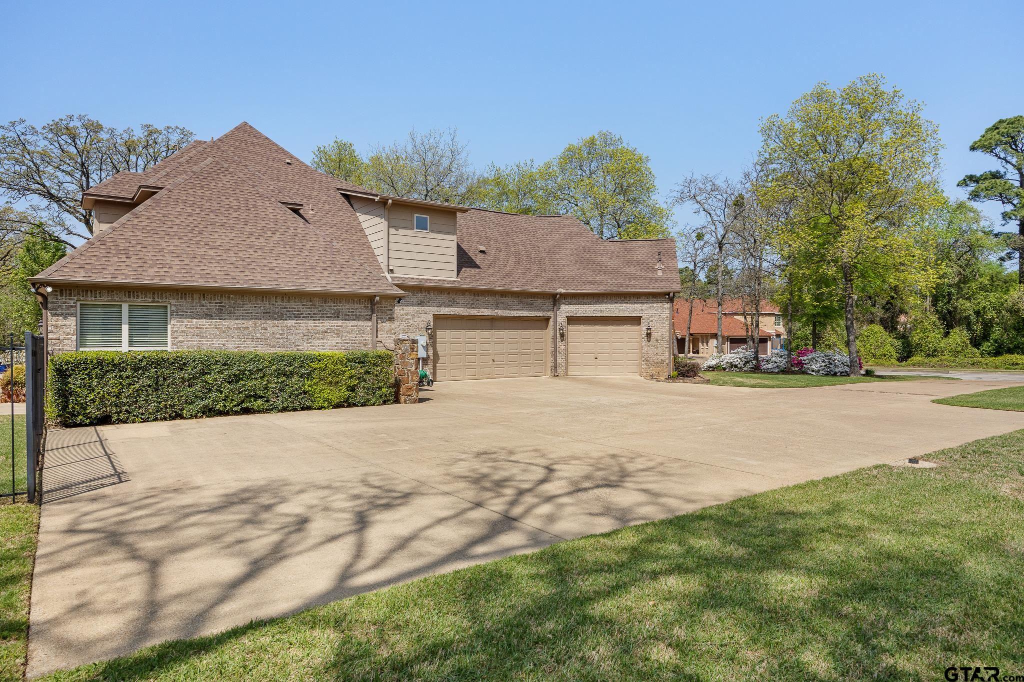 5875 Stonegate Trail Tyler, TX 75703 - Photo 41 of 47 a front view of a house with a yard and garage