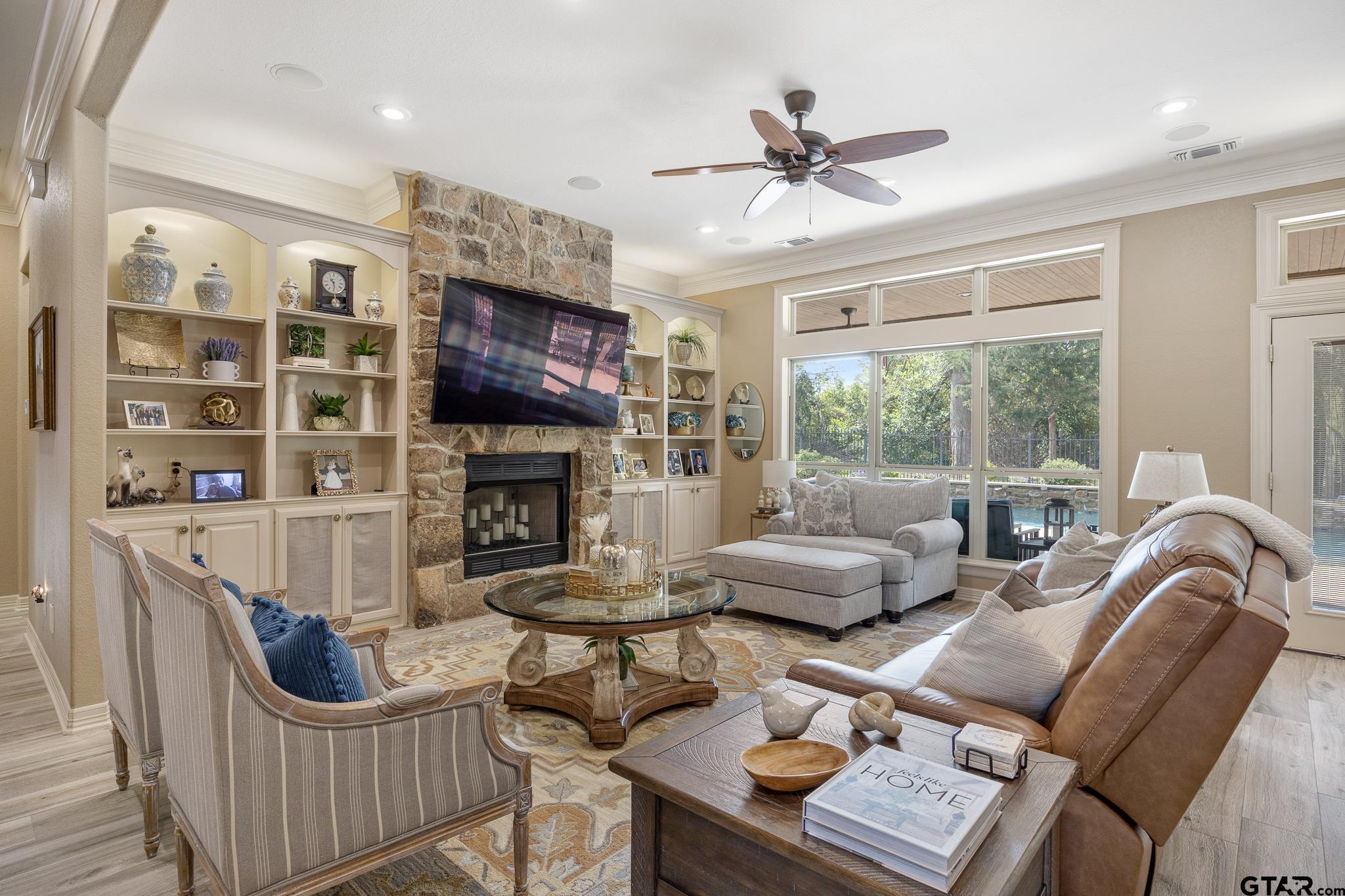 5875 Stonegate Trail Tyler, TX 75703 - Photo 10 of 47 a living room with furniture a fireplace and a flat screen tv