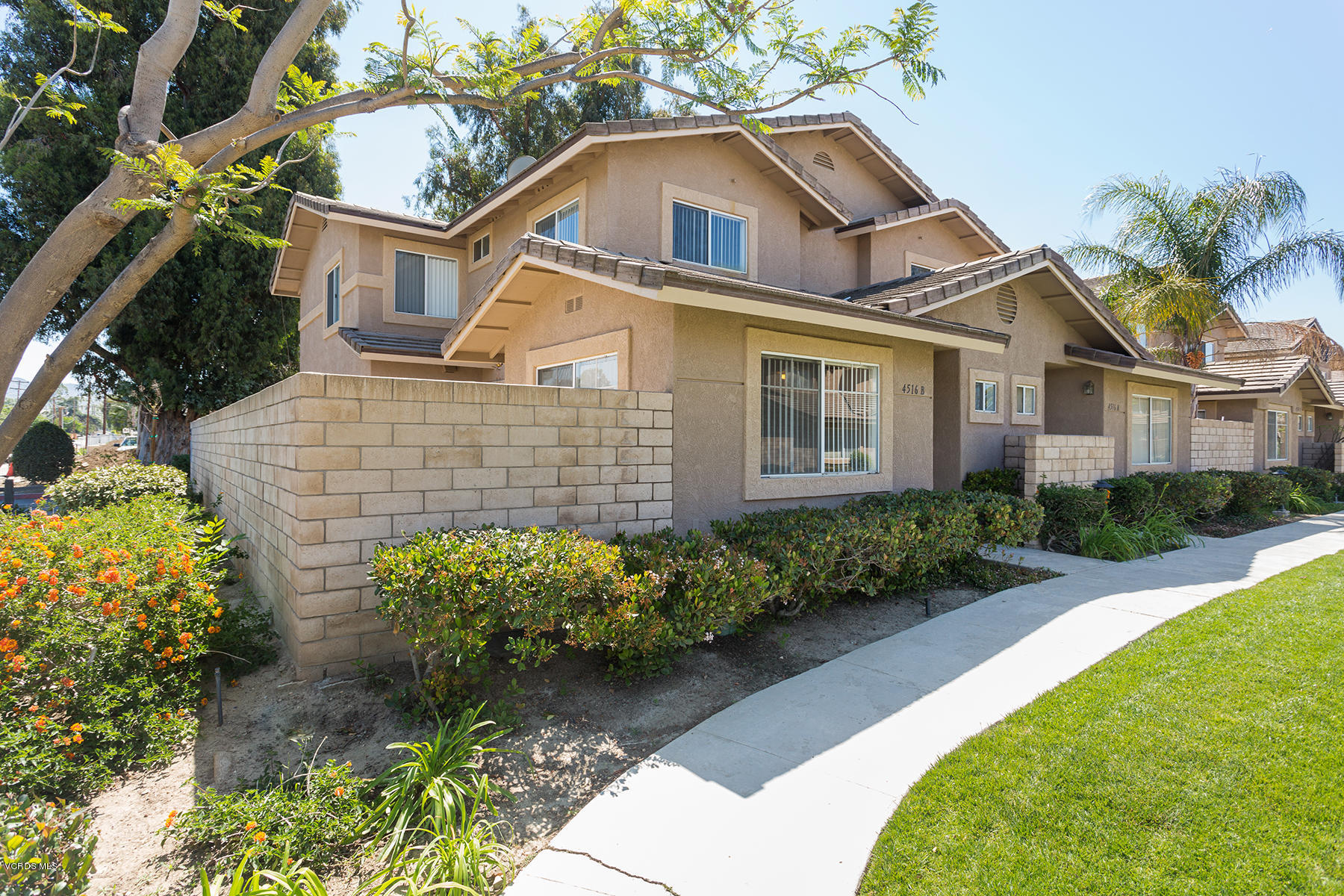 4516 Apricot Road, Unit B Simi Valley, CA 93063 - Photo 1 of 24 a front view of a house with a garden