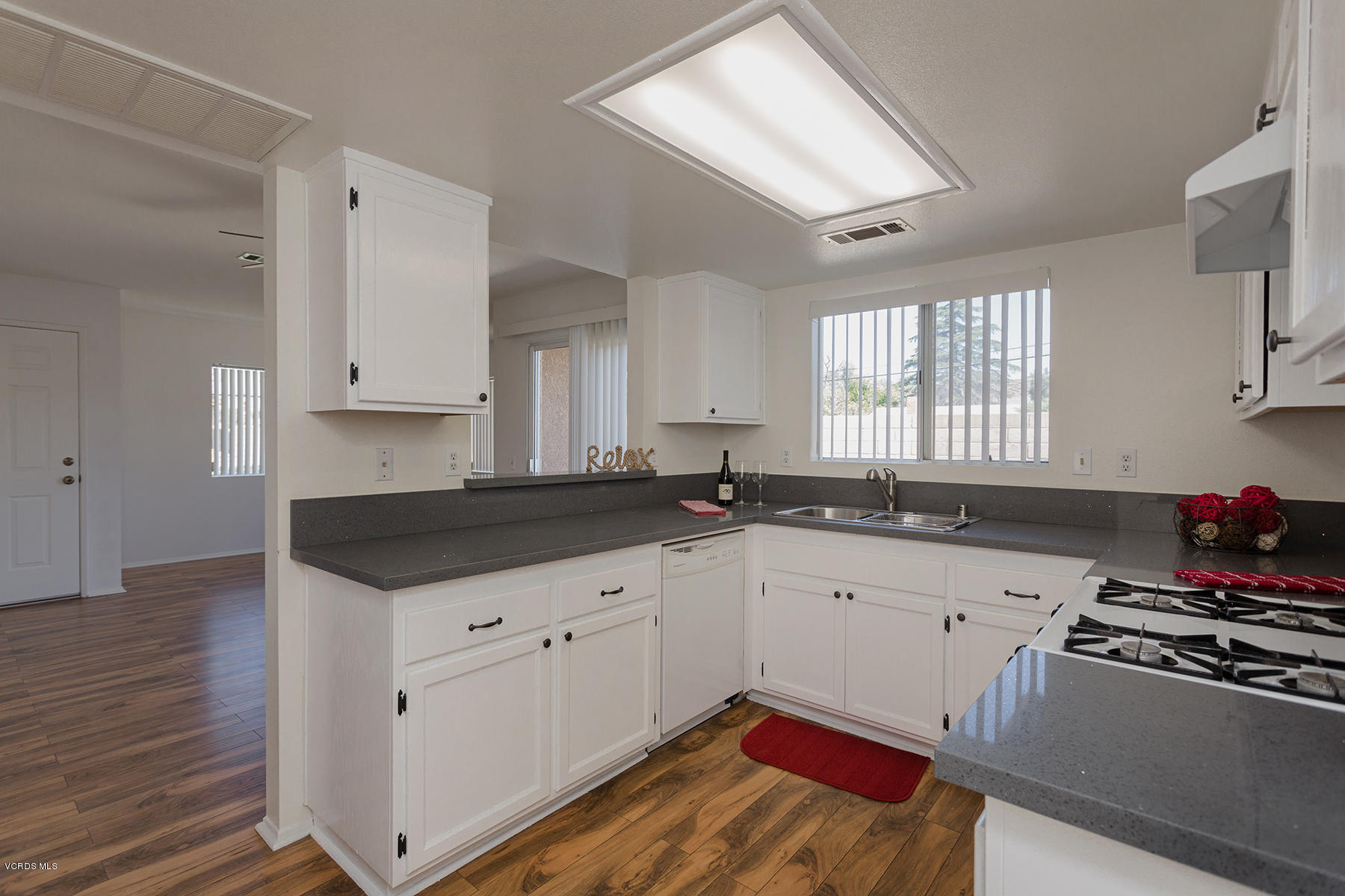 4516 Apricot Road, Unit B Simi Valley, CA 93063 - Photo 4 of 24 a kitchen with granite countertop a sink a stove and cabinets