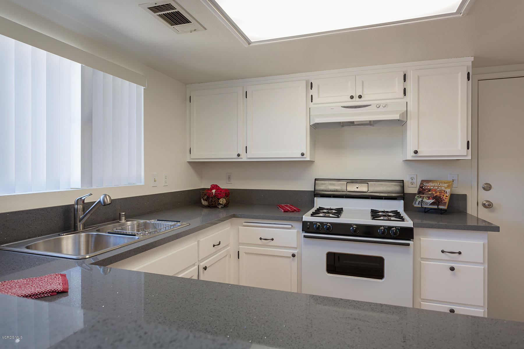 4516 Apricot Road, Unit B Simi Valley, CA 93063 - Photo 6 of 24 a kitchen with cabinets appliances a sink and a counter top